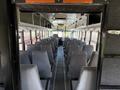 Interior view of a 2009 International 3000 CE school bus featuring rows of gray seats lined along the aisle with a driver's area visible at the front