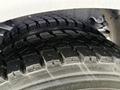 Close-up of a rugged tire from a 2016 Freightliner 108SD displaying deep tread patterns designed for traction and durability