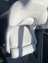 A white leather boat seat from a 2013 Larson 238 with a modern design and contours for comfort