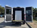 A 2022 RAM Promaster 350 with double rear doors open revealing a large perforated metal panel positioned inside
