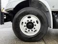 A close-up view of the tire and wheel of a 2020 International MV607 showcasing the Goodyear brand and a white rim with multiple bolts