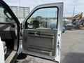 A 2008 Ford F-550 truck with its door opened showing the interior design and controls