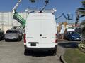 A 2023 Mercedes-Benz Sprinter 2500 van viewed from the rear with a roof rack and rear doors closed