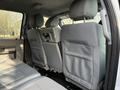The interior of a 2015 Ford F-550 showing the back seats with gray upholstery and headrests visible