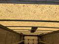 Interior view of a 2012 Ford Econoline van showing the ceiling with a textured surface and a ventilation fan in the center