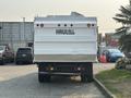 A 2009 Ford F-550 with a white dump truck bed and the text HAU-ALL displayed on the back