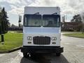 A white 2017 Freightliner MT45 box truck with large front windows and side mirrors facing forward