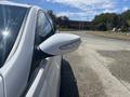 Side mirror of a 2014 Hyundai Sonata with water droplets on its surface showcasing integrated turn signal lights