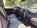 Interior view of a 2013 RAM 2500 featuring gray fabric seats dashboard infotainment system and gear shift