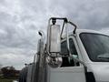 A 2016 Peterbilt 348 truck with chrome side mirrors and a polished exhaust stack showing a reflection on the mirror surface