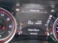 The dashboard display of a 2017 Dodge Charger showing vehicle information including engine hours and total kilometers driven