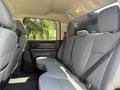 Interior view of the back seat of a 2013 RAM 2500 featuring gray upholstery with seatbelts and a spacious seating area