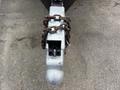 A metal trailer hitch with a secured lock and chain attached