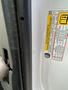 A 2022 GMC Savana with a visible door label featuring safety and maintenance information