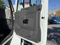 The image shows the door of a 2010 International 4300 truck with a gray interior panel and a handle for opening the door