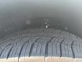 A close-up view of a tire with an intricate tread pattern mounted on a 2017 Chevrolet Colorado
