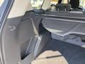 Interior view of a 2016 Ford Escape showing the cargo area with a black fabric cover and a side panel with storage space