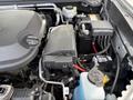 Engine compartment of a 2018 Chevrolet Colorado showing the battery coolant reservoir and various components including wiring and fuses