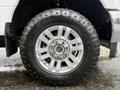 Close-up of a silver wheel with a large black tire labeled Goodyear Wrangler on a 2019 Ford F-350 SD