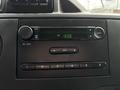 Dashboard of a 2017 Ford Econoline showing a digital clock radio with buttons for volume and tuning