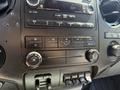 Dashboard controls of a 2014 Ford F-250 SD displaying buttons for audio and climate settings