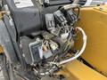 A close-up view of the engine compartment of a 2014 Vermeer Corporation Sweep Stump Cutter highlighting electrical connections and components