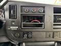 Dashboard of a 2015 Chevrolet Express featuring control knobs and an empty slot for a radio with various buttons and indicators visible