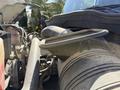 Close-up of the engine components of a 2008 International 7500 with visible air intake and various pipes and fittings