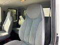 The image shows the interior of a 2006 International 4300 featuring a driver's seat and two passenger seats with gray fabric upholstery