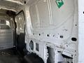 Interior view of a 2017 Ford Transit van showing the cargo area with bare walls and a metal partition in place