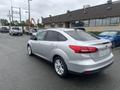 A silver 2018 Ford Focus parked with its rear visible showing sleek design and alloy wheels