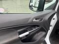 The interior door panel of a 2017 Ford Transit Connect featuring a door handle power window controls and a speaker in a simple black design