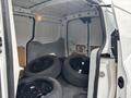 A 2019 Ford Transit Connect cargo van interior with four black tires stacked inside