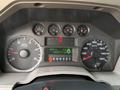 The dashboard of a 2010 Ford F-550 displaying various gauges including speedometer tachometer fuel level and a trip computer