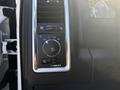 Control panel of a 2018 RAM 3500 featuring buttons and a dial for climate control and lighting adjustments