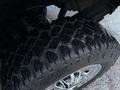 Close-up of a rugged tire tread on a 2017 GMC Sierra 3500HD showcasing deep grooves and a shiny chrome wheel