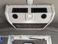 The ceiling-mounted air conditioning unit of a 2014 Ford E-350 designed for passenger comfort with multiple vents for airflow