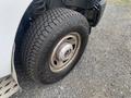 Close-up of a tire from a 2014 Ford F-350 SD showcasing the tread pattern and rim design