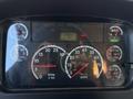 Dashboard of a 2011 Freightliner M2 106 showing gauges for RPM speed fuel water pressure and a small display for odometer and other metrics