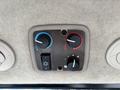Control panel for climate settings featuring three knobs in blue and red for temperature and airflow adjustment, along with a switch for the air conditioning unit