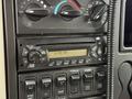 Dashboard control panel of a 2012 International TerraStar featuring a radio display and various buttons and switches for vehicle functions