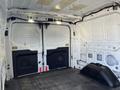 Interior of a 2017 Ford Transit cargo van showing the rear doors and cargo area with a flat floor and no cargo present