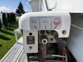 Control panel of a 2008 International 7500 featuring buttons for engine speed upper controls lower controls and an emergency stop