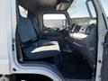 Interior of a 2014 Mitsubishi Fuso FE featuring two seats and a dashboard with various controls and displays