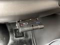 A Reese brake controller mounted under the dashboard of a 2004 Chevrolet Express