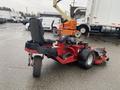 A 2017 Ferris Rotary lawn mower with a large rear wheel a seat for the operator and an exposed engine area showcasing its compact design and powerful mowing capabilities