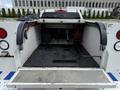 The image shows the open bed of a 2017 Chevrolet Colorado with a metal floor and equipment stored inside