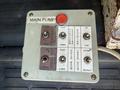 Control panel with buttons for operating various functions including main pump upper and lower control and adjustments for boom rotation and extension