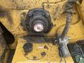 Close-up of a 2010 Vermeer Corporation BC1000XL chipper showing the control panel and engine components with dirt and wear visible