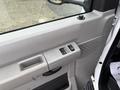 Interior door panel of a 2017 Ford Econoline featuring window controls and a textured handle area